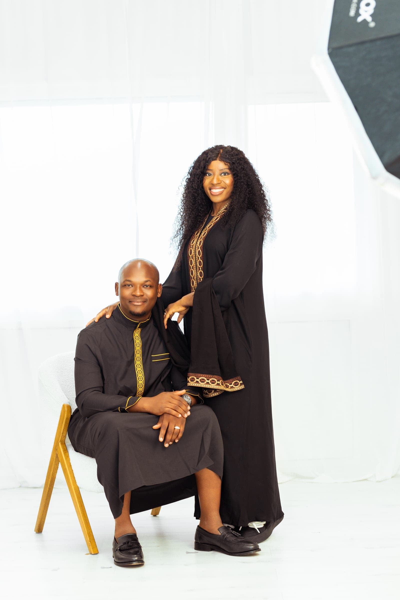 The same pairing framed with the softbox in shot at the edge, the pair of them lit against the white studio.