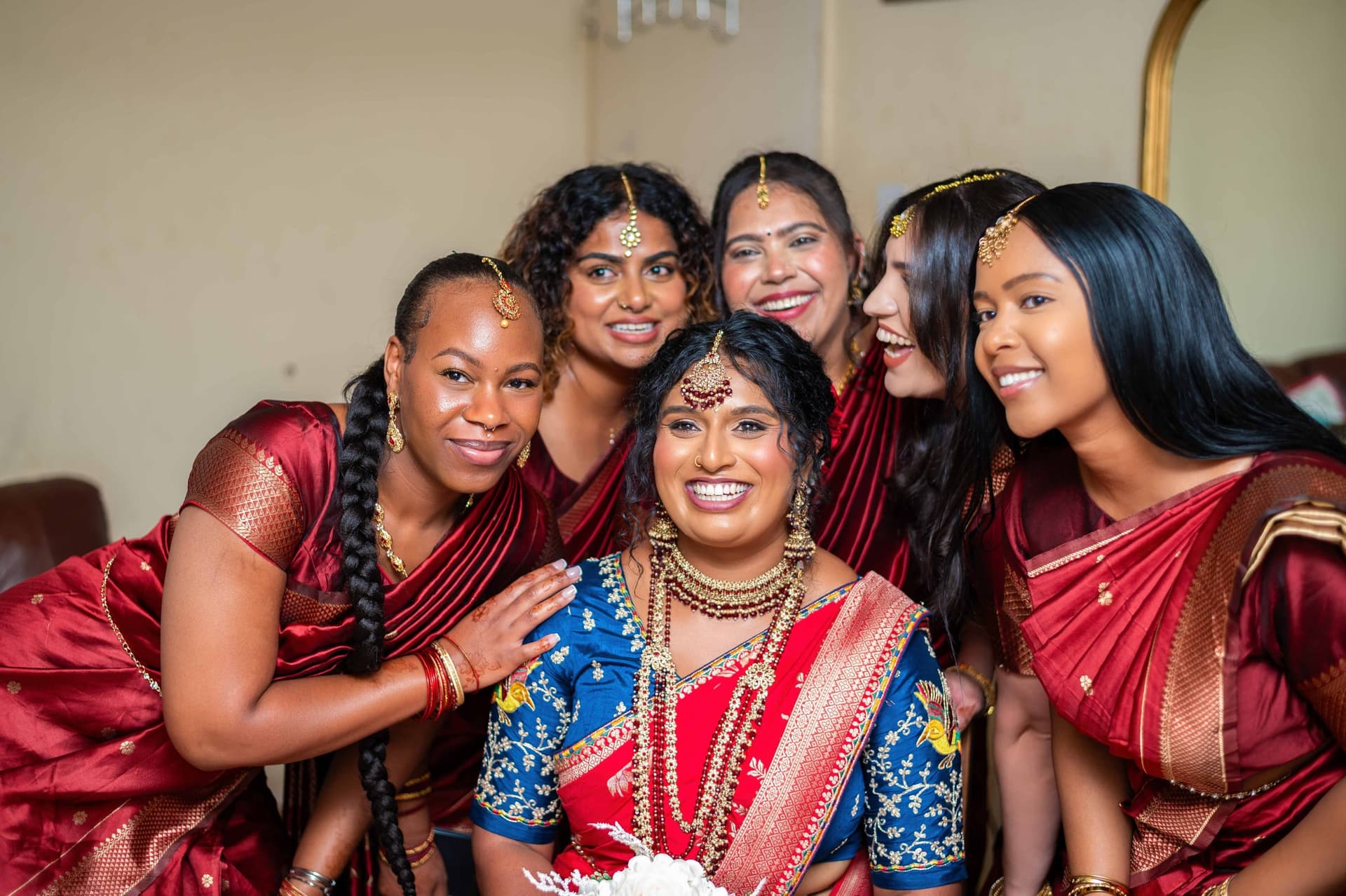 The same group a second later, everyone laughing at the camera, one hand resting on the bride's shoulder.