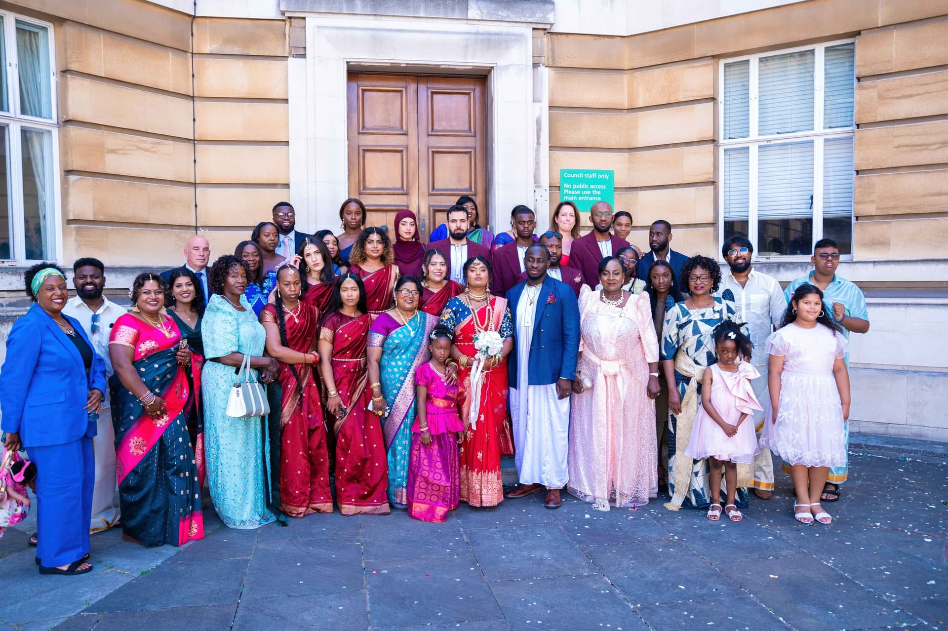 The full group of guests gathered on the stone forecourt outside the town hall.