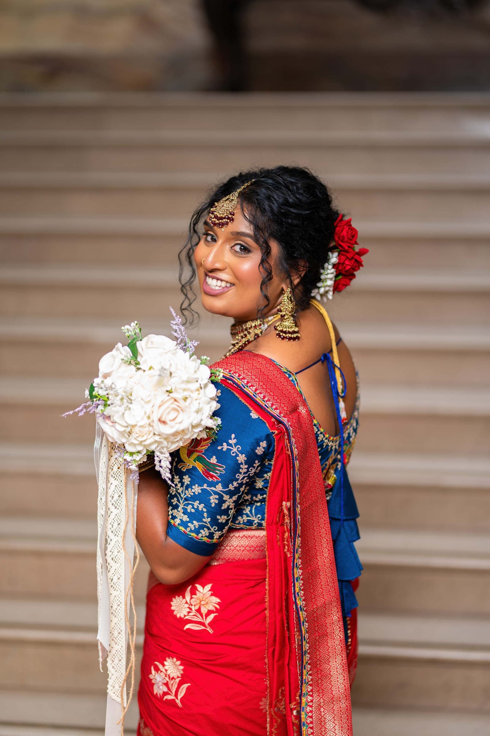 The same look framed tighter, the beadwork of her blue blouse catching the light.